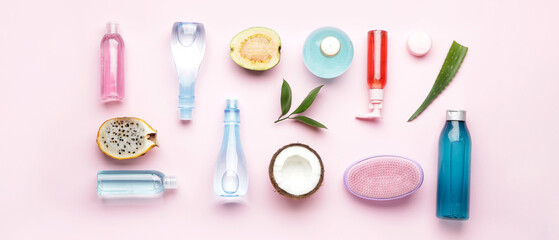 Set of natural cosmetics with tropical fruits on pink background