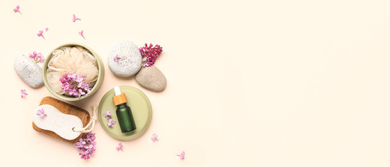 Bottle of serum with spa stones, pumice and bast wisp on light background with space for text