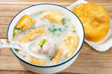 angle view fish porridge with deep-fried Chinese donuts at horizontal composition