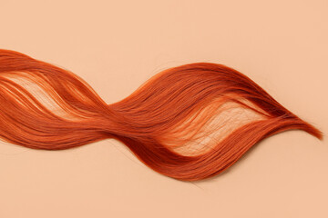 Red hair strand on color background, closeup