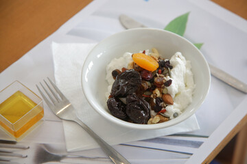 Greek yoghurt in bowl with honey, nuts, seeds and dried fruits, healthy breakfast diet