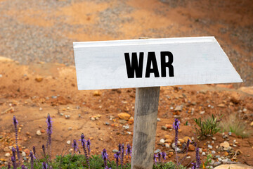 white wooden signpost with the word war