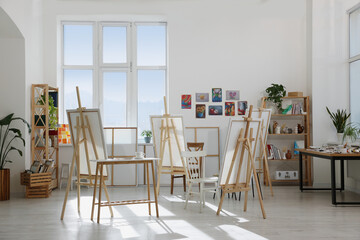 Stylish artist's studio interior with easels and canvases. Creative hobby