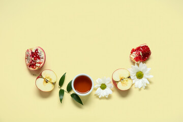 Composition with fresh apple, pomegranate, honey and flowers on color background. Rosh hashanah (Jewish New Year) celebration
