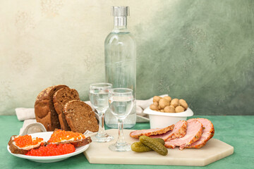 Shots with cold vodka and snacks on table