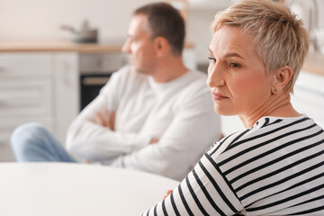 Offended mature woman after quarrel with her husband in kitchen, closeup