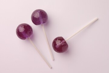Tasty lollipops on white background, flat lay