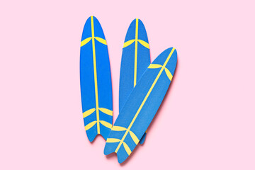 Mini surfboards on pink background