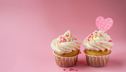 Vanilla cupcakes with cream cheese frosting and pink sprinkles on pink background. Saint Valentine's day or birthday dessert. Beautiful festive food for wedding or baby shower girl. Copy space.