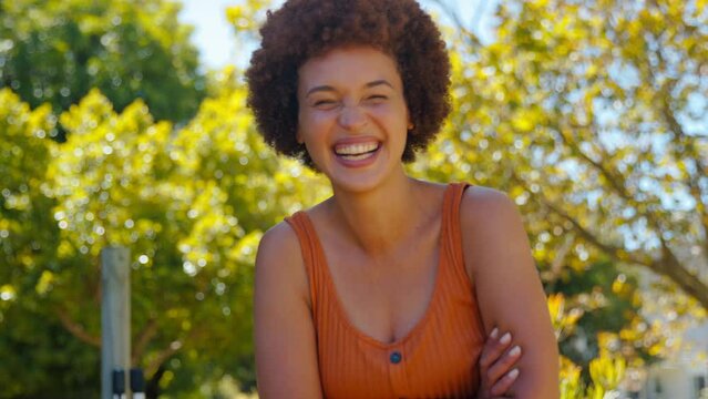 Portrait of smiling woman outdoors in garden at home - shot in slow motion