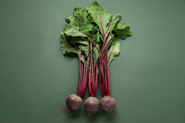 Fresh beetroots on green background
