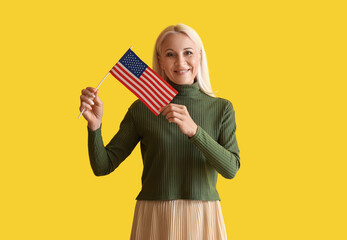 Mature woman with USA flag on yellow background
