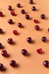 Many sweet cherries on orange background