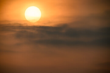 The sun moves towards the horizon. Occasionally obscured by dark clouds. Fugui Cape Lighthouse is known for its sunset shots and tourist attractions.