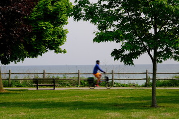 Bike quickly ride along the bike path of shore of the lake