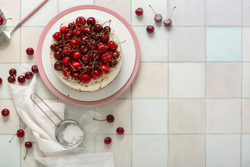 Plate with tasty cherry cake on white tile background