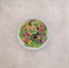Centered recipient with fruit gummy on gray cement floor