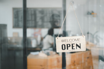 Open sign broad through the glass of door in cafe. Business service and food concept.
