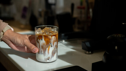 Coffee in a glass on the counter of a coffee shop