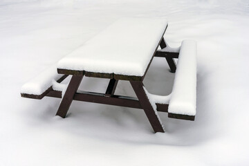 Snow covered wooden picnic table