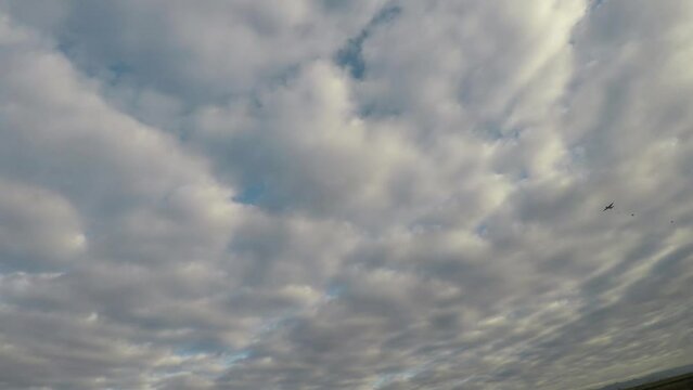 military logistics transport plane launching 32 paratroopers on a cloudy day at dawn