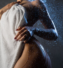 Nude beautiful woman having shower low angle view