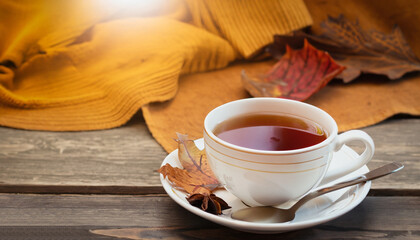 a cup of tea on a wooden table, the concept of autumn and home comfort