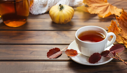 a cup of tea on a wooden table, the concept of autumn and home comfort