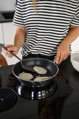 Crop woman cooking in kitchen