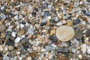 Crushed stone on the seashore. Selective focus on object. The stones were laid on the ground in the garden as a background. Background blur. Pebble stones background.