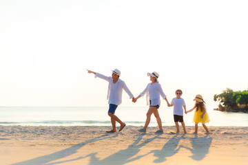 Happy family having fun playing on the beach. Summer and Travel Concept. Happy family on vacation.