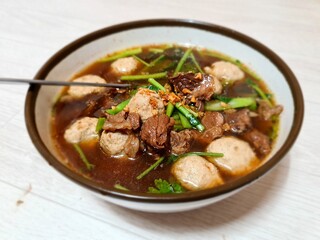 Thai khaolao is a dish of tender meat and vegetables cooked in broth or sauce, without noodles. It originated from a Chinese dish called gaolou, meaning skyscraper, which was the name of a famous rest