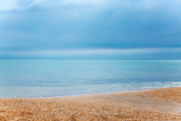 Fototapeta na wymiar Sandy beach and turquoise sea with blue skies. Beautiful nature. Tourism, travel and recreation.