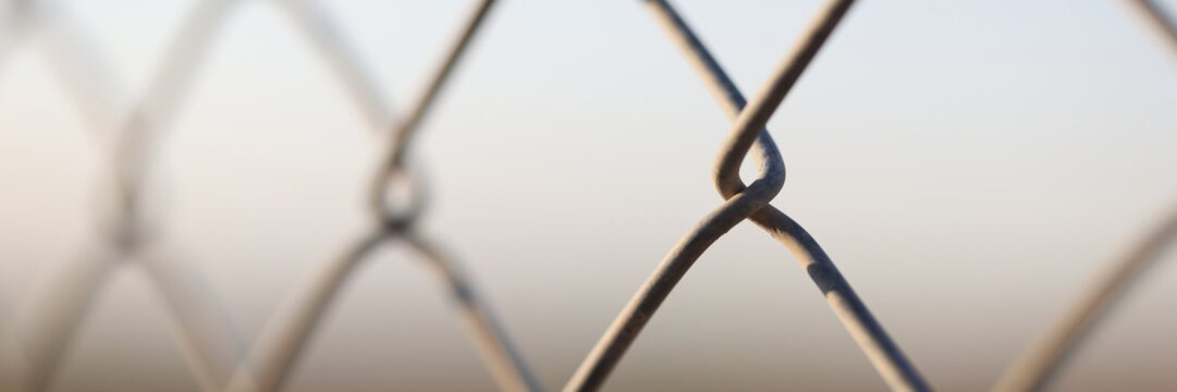 Metal chain links wire-mesh rabitz on blurred background