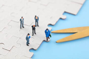 Miniature photography workplace layoffs puzzle scissors