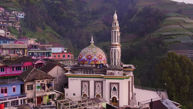 Low angle drone shot of Mosque of nepal van java and peak of Mount Sumbing, aerial