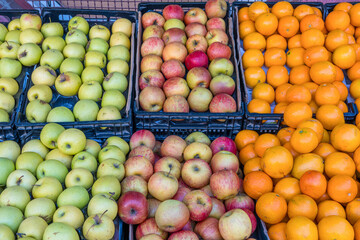 Apples and tangerines for sale at a market