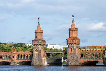 The famous Oberbaumbruecke in Berlin with a yellow metro train