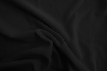 Abstract black wavy cloth. Dark fabric background.