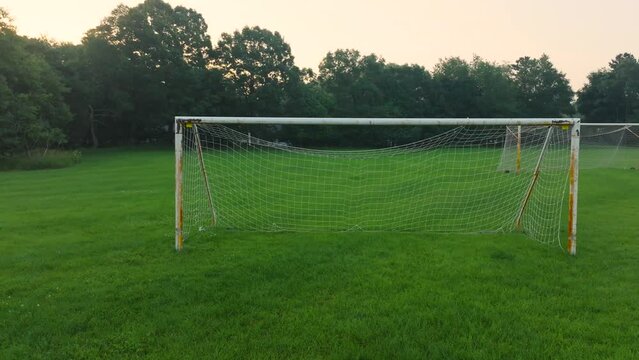 Leftward motion viewing a rusty soccer net.