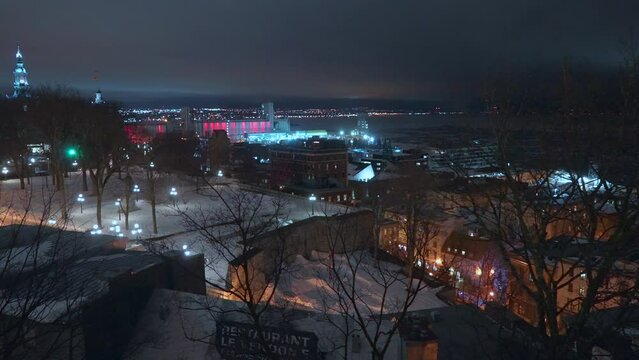 Cinematic Quebec City center Canada cold winter evening night time downtown center Quai Lookout Point St Lawrence River street church peaceful snow on ground slow pan to the left panorama movement