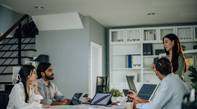 Startup team presents innovative, sustainable solar cell prototype. Reduce electricity costs, resource consumption, carbon footprint. Foster creative communication, eco-friendly decision-making.