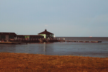 Rest zone. Embankment, pier and beach. Wooden platform.