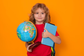 Fototapeta premium Knowledge day. School boy hold world globe and book, isolated on yellow studio background. School and kids. Cute blonde child with a book learning. Knowledge day.