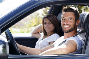 portrait of an attractive couple in their car