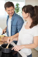 portrait of a cheerful young couple cooking together