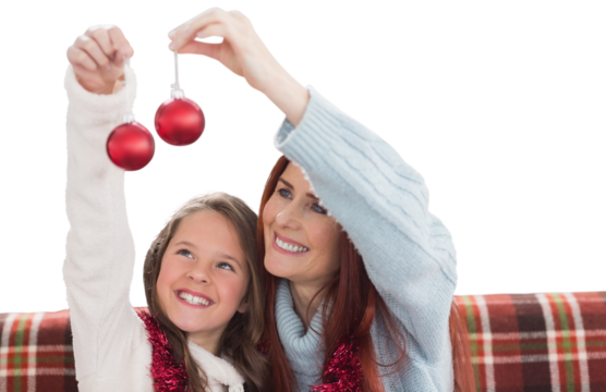 Digital png photo of happy causian mother and daughter holding baubles on transparent background