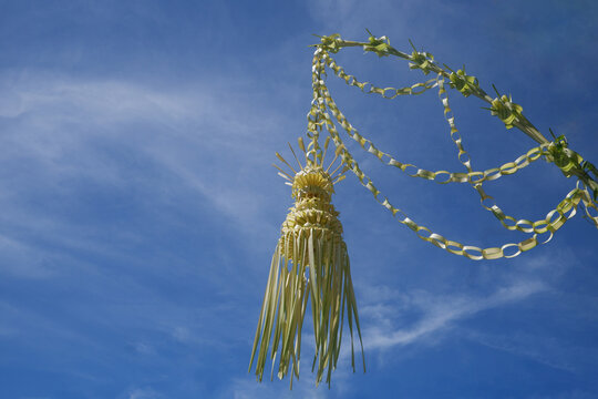 a traditional artwork from Indonesia made from young yellow coconut leaves called janur kuning, commonly used as a sign of a wedding ceremony