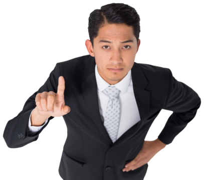 Digital png photo of serious asian businessman pointing with finger on transparent background