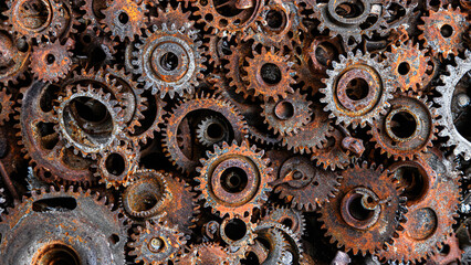 many old rusty metal gears or machine parts